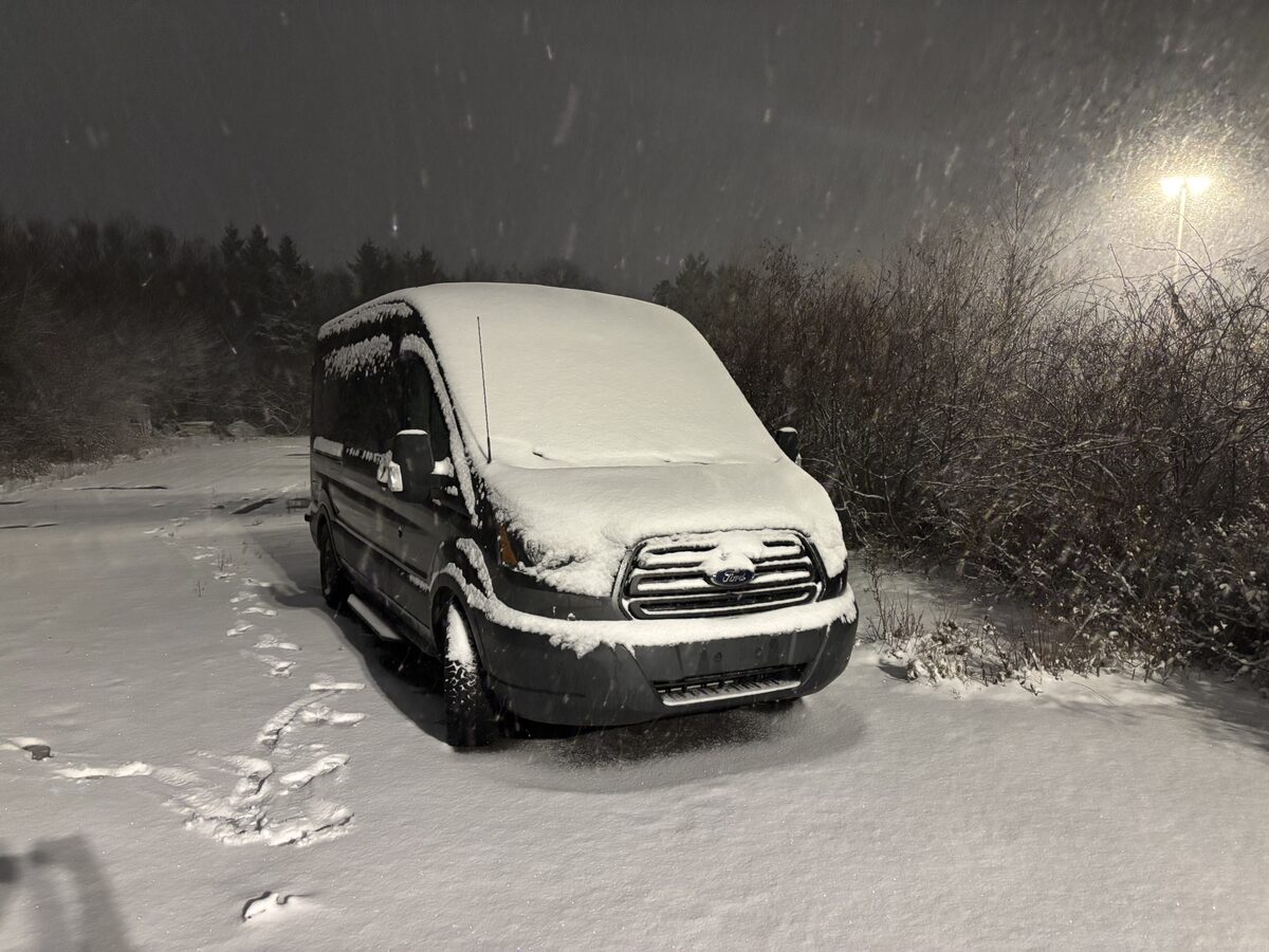 The CapnCoil Transit parked in heavy snowfall during winter systems testing.